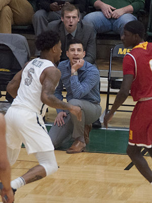 Southern men’s basketball coach Jeff Boschee (foreground) and assistant Paul McMahon communicate with players on defense during the home game against Pittsburg State.