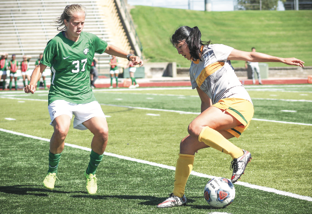Sophomore Carina Calderon tries to maintain possession of the ball while a Riverhawks defender approaches her, in Fred G. Hughes Stadium, in Joplin, Mo.