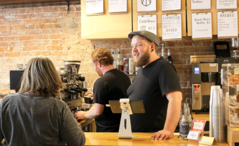 The owner of Bearded Lady Coffee Roasters, Adam Francis, serves a customer. 