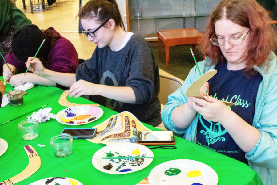 Haylee Pyburn (left), a psychology major and freshman, Anna Baker (Middle), an undeclared major and sophomore, Linda Switzerland (Right), a nursing major and sophomore, paint their boomerang between classes in Billingsly Student Center as an activity for the Oceanic Semester on Wednesday, Nov. 13. 