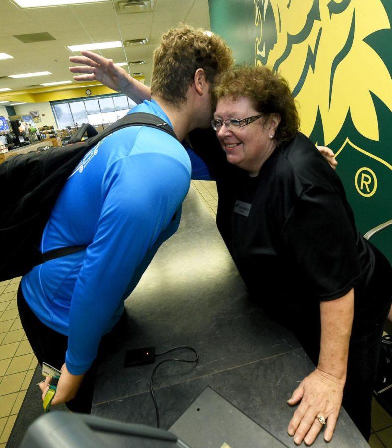 Missouri Southern football player Aiden Brown hugs Denise Terry, know as Momma D near her cashier station in the Mayes Dining Hall