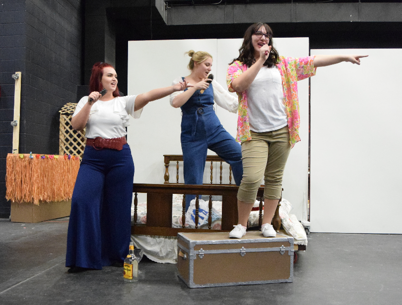 (left to right) Baylee Scribner, Michaela West, and Faith Escobar rehearse “Dancing Queen” as Donna and the Dynamos.  