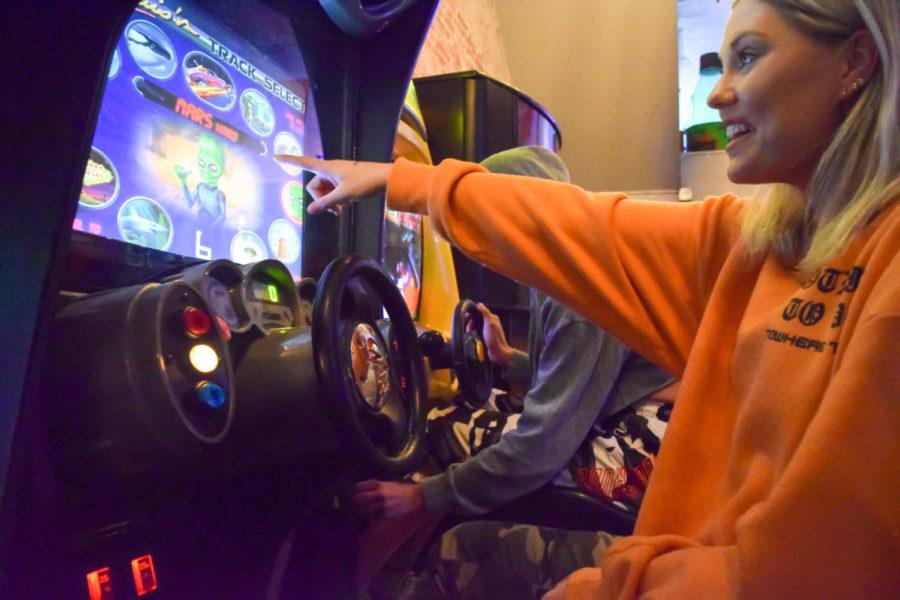 Jessica Greninger, former Missouri Southern student is seen playing a racecar videogame at Flicker: Arcade & Bar located at 122 S Main St. in Joplin, Mo.