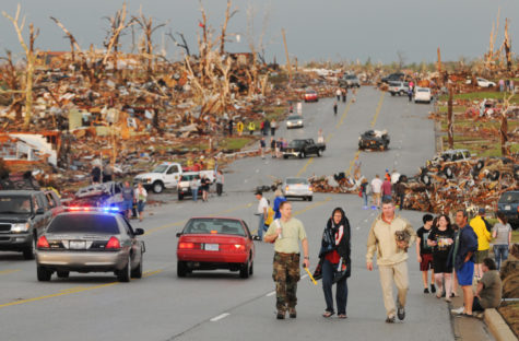 Survivors walk west down 26th street in Joplin, Mo, near St. Johns Hospital after a tornado hit Joplin, Mo, on Sunday, May 22, 2011.