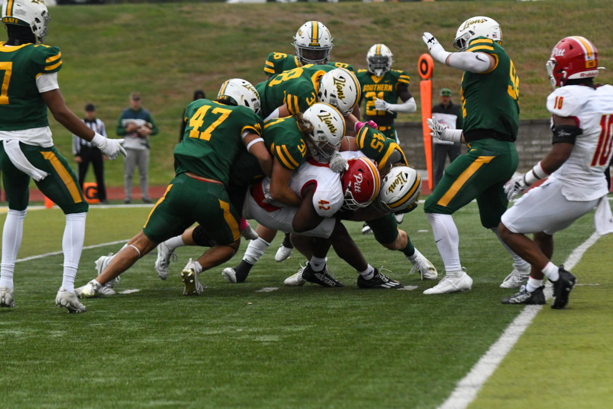 A group of Lions defenders bring down the ballcarrier at Fred G Hughes Stadium in Joplin, Mo on Oct. 14, 2023