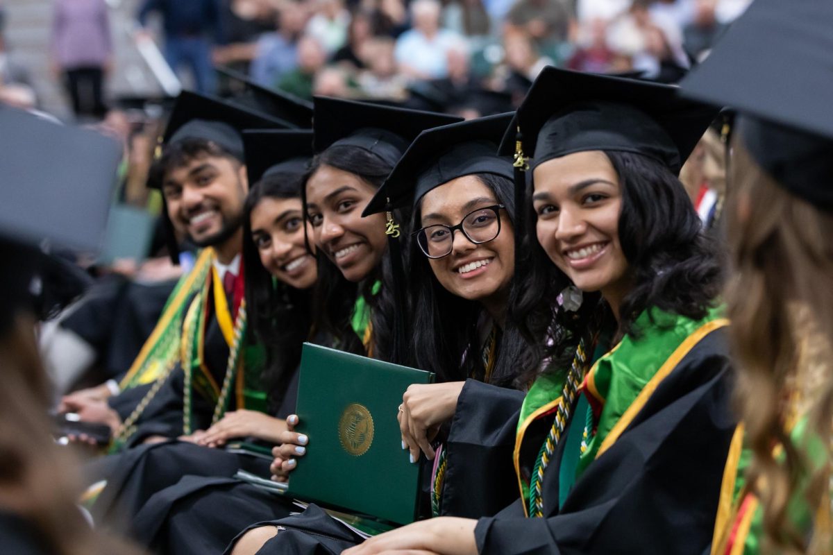 Students receive their diploma covers at the commencement ceremony May 10, 2025