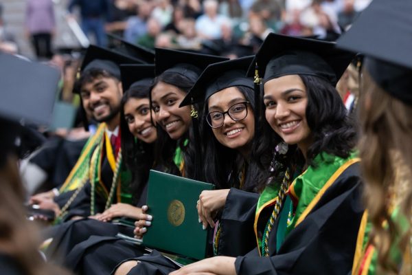 Students receive their diploma covers at the commencement ceremony May 10, 2025